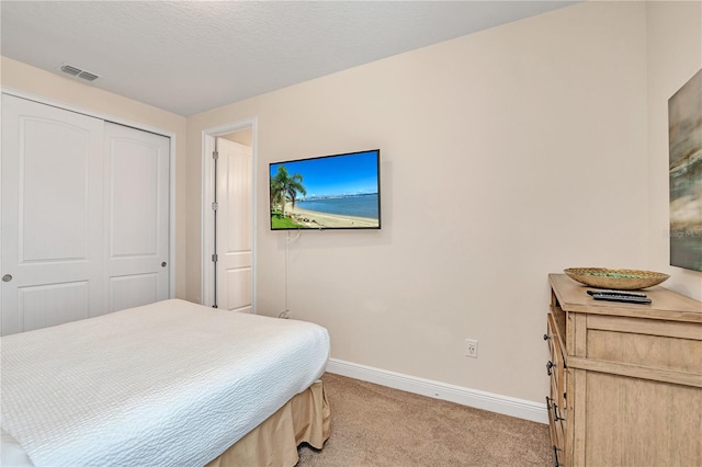 carpeted bedroom with a closet