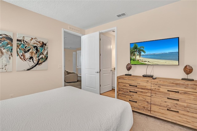 carpeted bedroom with a textured ceiling