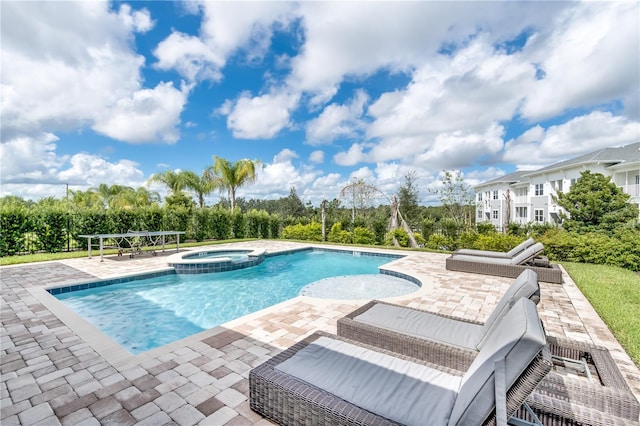 view of swimming pool featuring a patio area and an in ground hot tub