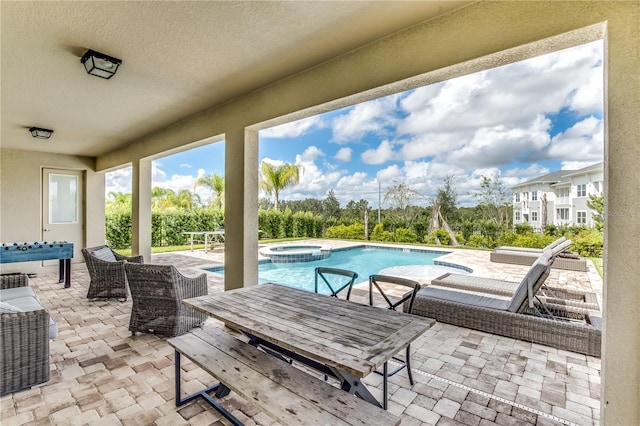 view of patio featuring a swimming pool with hot tub