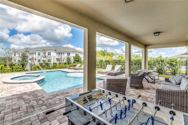 view of pool featuring a patio and an in ground hot tub