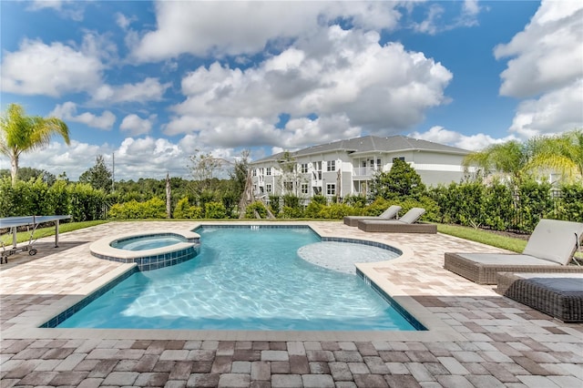 view of swimming pool featuring a patio area and an in ground hot tub