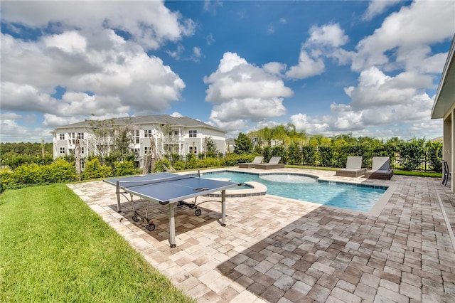 view of pool featuring a patio and an in ground hot tub