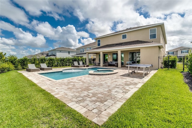 view of swimming pool with a patio, a yard, and an in ground hot tub