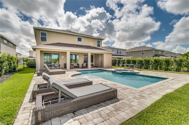 view of swimming pool featuring a patio area and an in ground hot tub