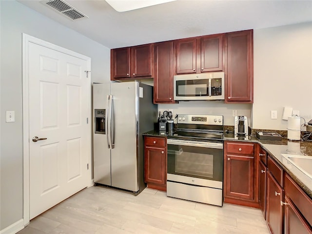 kitchen with light hardwood / wood-style flooring and stainless steel appliances