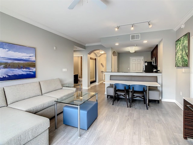 living room with ceiling fan, light hardwood / wood-style flooring, track lighting, and ornamental molding