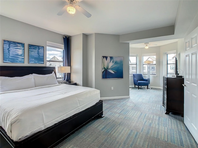 carpeted bedroom with multiple windows and ceiling fan