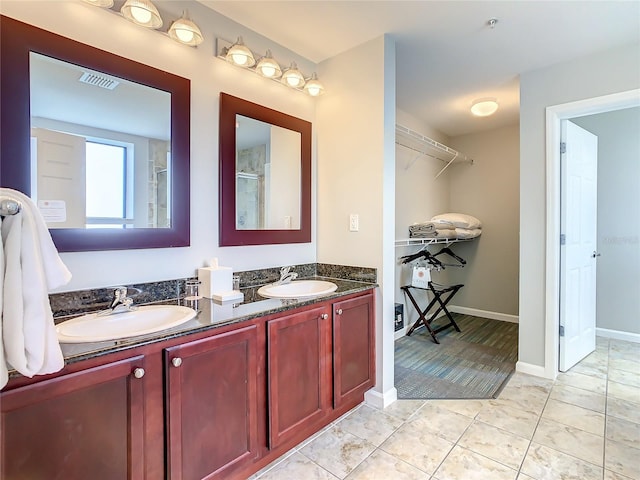 bathroom featuring tile flooring and double sink vanity