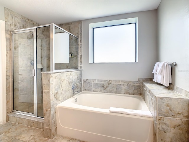 bathroom with tile floors and separate shower and tub