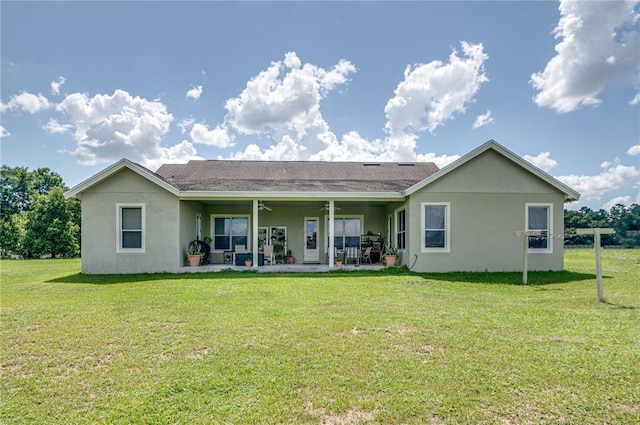 rear view of house with a lawn and a patio area