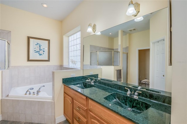 bathroom featuring dual sinks, plus walk in shower, and oversized vanity