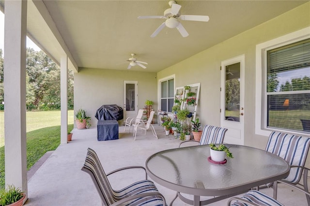 view of terrace with ceiling fan and a grill