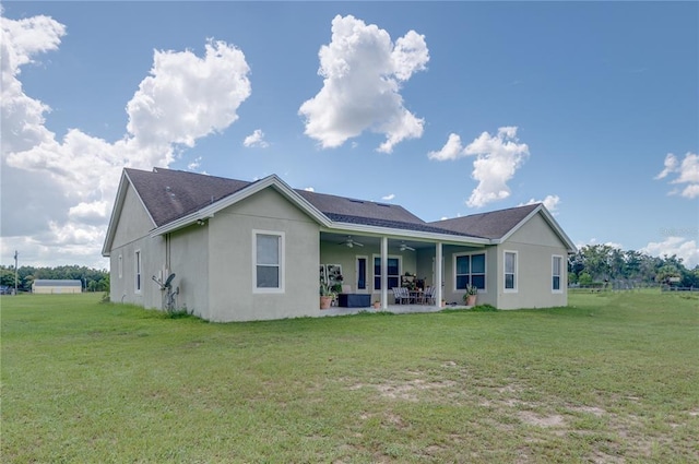 back of property featuring a lawn and a patio