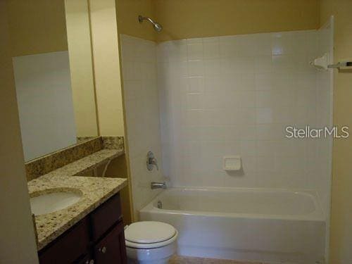 full bathroom with shower / bathing tub combination, toilet, and vanity