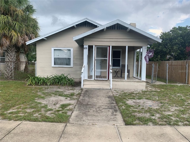 bungalow-style house with a porch and a front yard