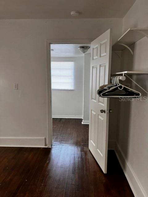 hall with dark wood-type flooring