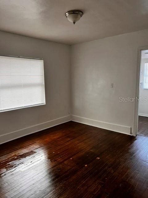 unfurnished room with dark hardwood / wood-style floors