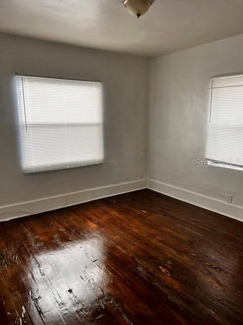 spare room with dark hardwood / wood-style floors