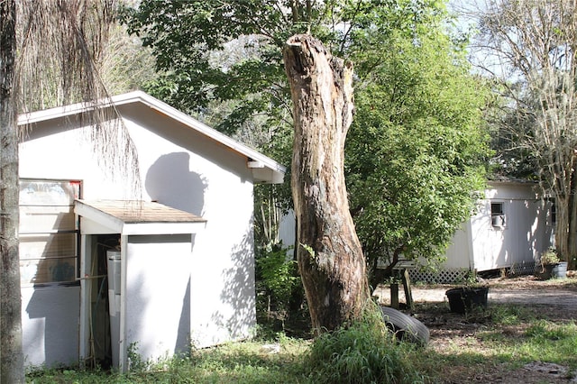 view of side of home with a storage shed