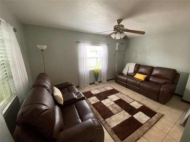 living room featuring a wall mounted air conditioner, ceiling fan, and light tile patterned floors