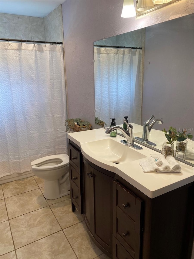 bathroom with tile patterned flooring, toilet, and vanity