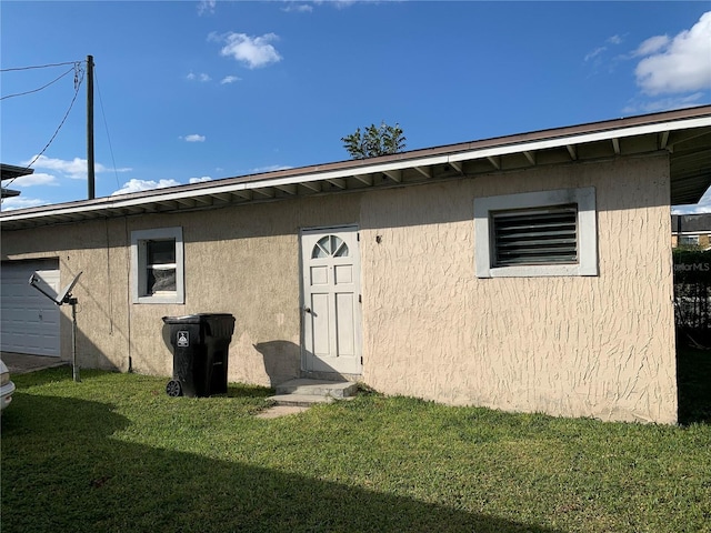 1023 W Gore St W, Orlando, FL 32805 - rear view of property with a lawn and stucco siding