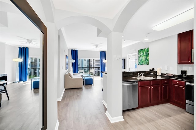 kitchen featuring sink, stainless steel dishwasher, stove, and light wood-type flooring