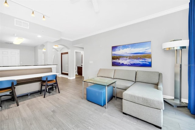 living room featuring light hardwood / wood-style flooring and ornamental molding