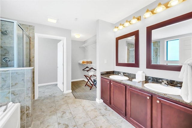 bathroom featuring tile patterned flooring, vanity, and walk in shower