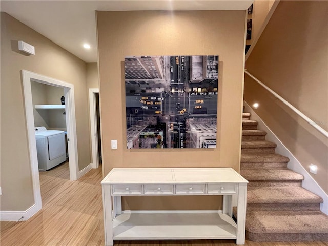 interior space featuring washer / clothes dryer, wood-type flooring, and bar area