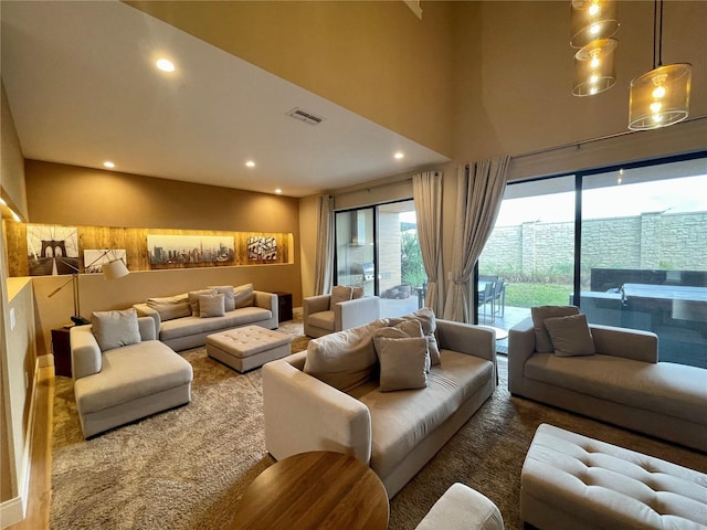 living area featuring recessed lighting and visible vents