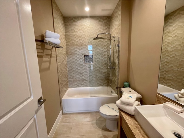 full bathroom featuring vanity, tiled shower / bath, tile patterned floors, and toilet