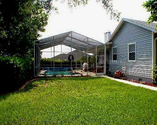 view of yard featuring glass enclosure