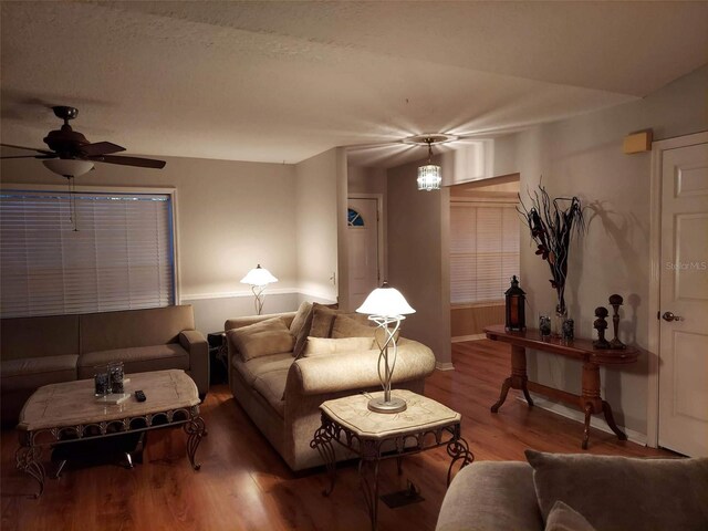 living room featuring wood-type flooring and ceiling fan