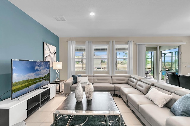 living room featuring light tile patterned floors and a healthy amount of sunlight