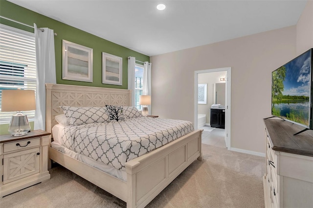 carpeted bedroom featuring connected bathroom