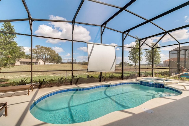 view of swimming pool featuring an in ground hot tub, a lanai, and a patio area