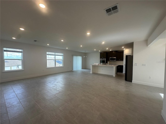 unfurnished living room with sink