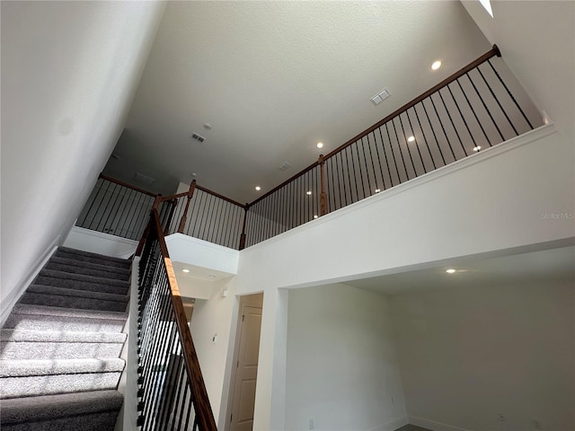 stairway with a towering ceiling