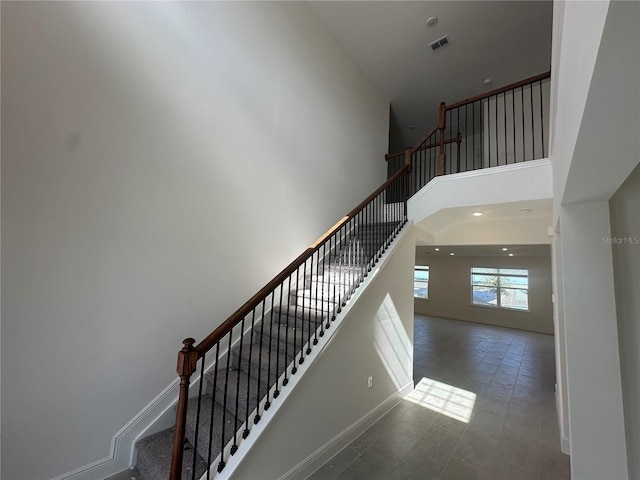 staircase with a high ceiling