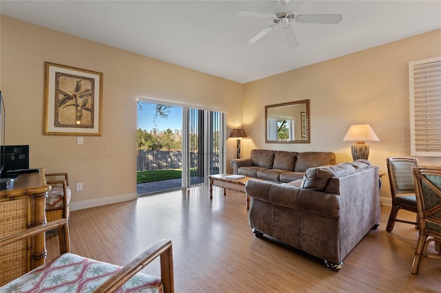 living room with ceiling fan and light hardwood / wood-style floors