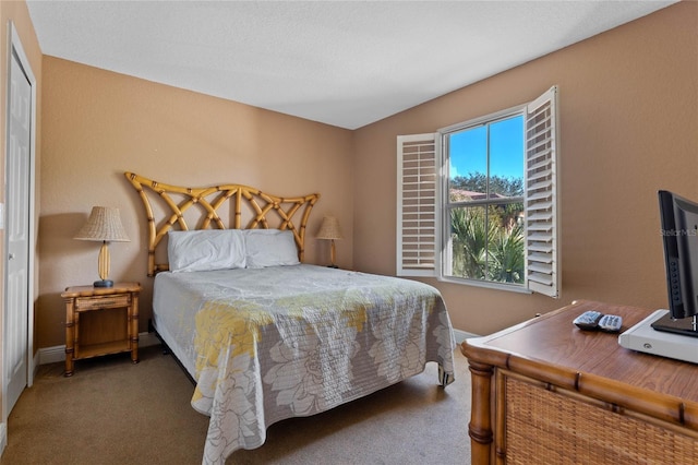 bedroom featuring dark carpet