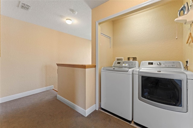 laundry area with carpet floors, a textured ceiling, and independent washer and dryer