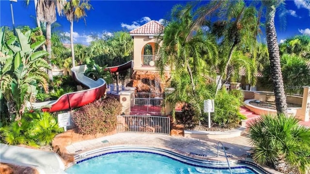 view of swimming pool with a water slide