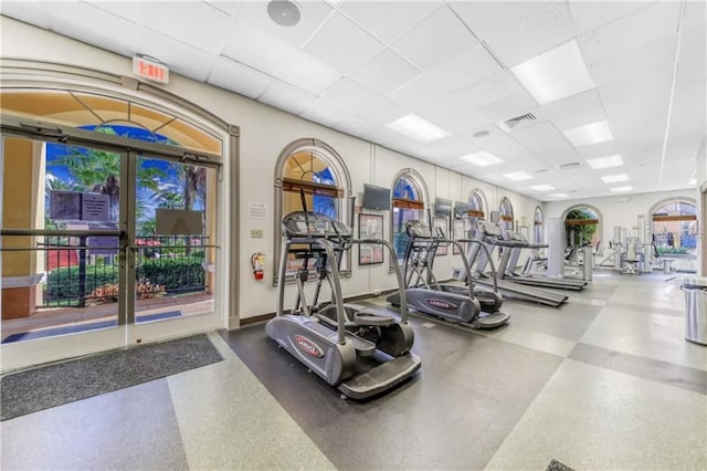 workout area featuring a drop ceiling and french doors