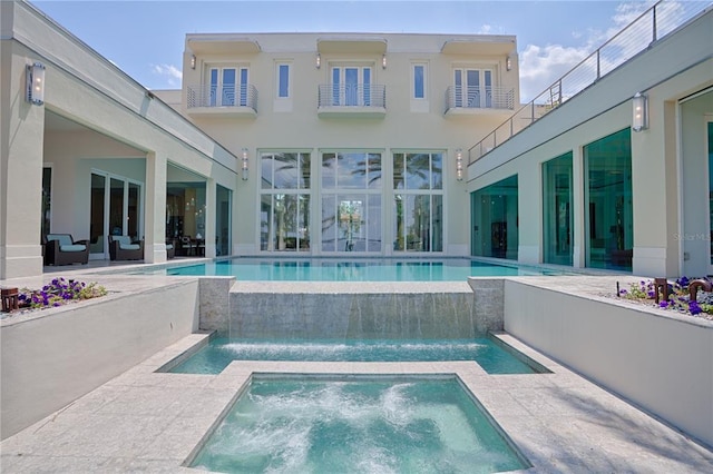 view of swimming pool with a patio area, an in ground hot tub, and pool water feature