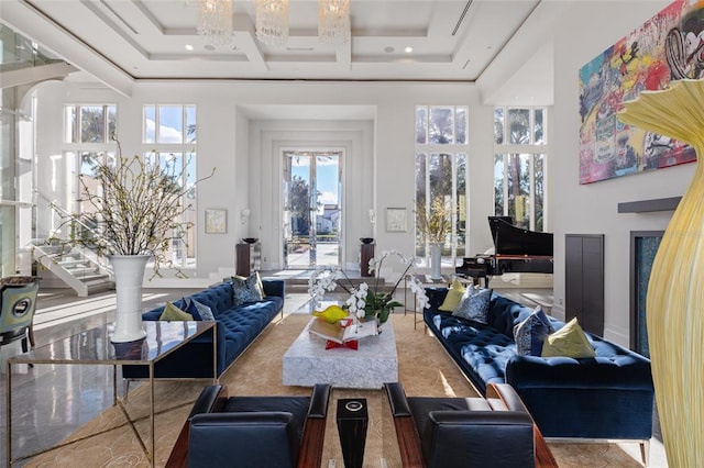 interior space featuring a tray ceiling, a notable chandelier, and a towering ceiling