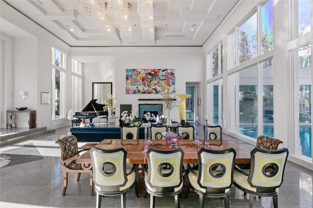 dining space featuring a chandelier, tile flooring, and a high ceiling