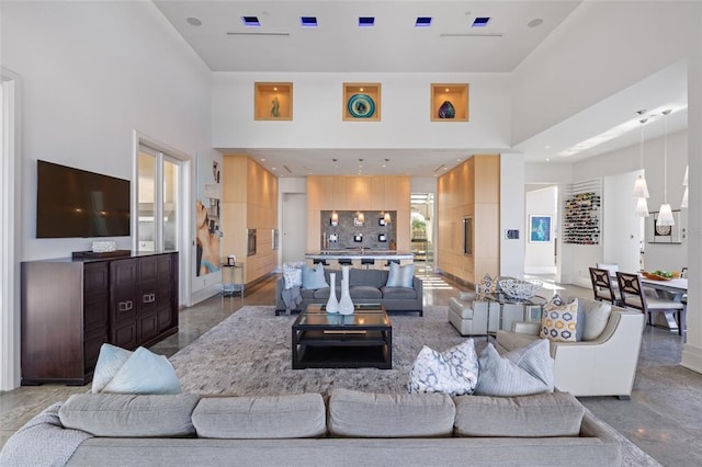 living room with tile floors and a towering ceiling